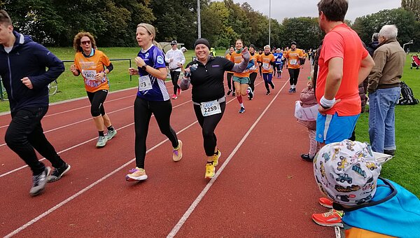 A Kroschu runner in the crowd on the running track at the Leukemia Run.