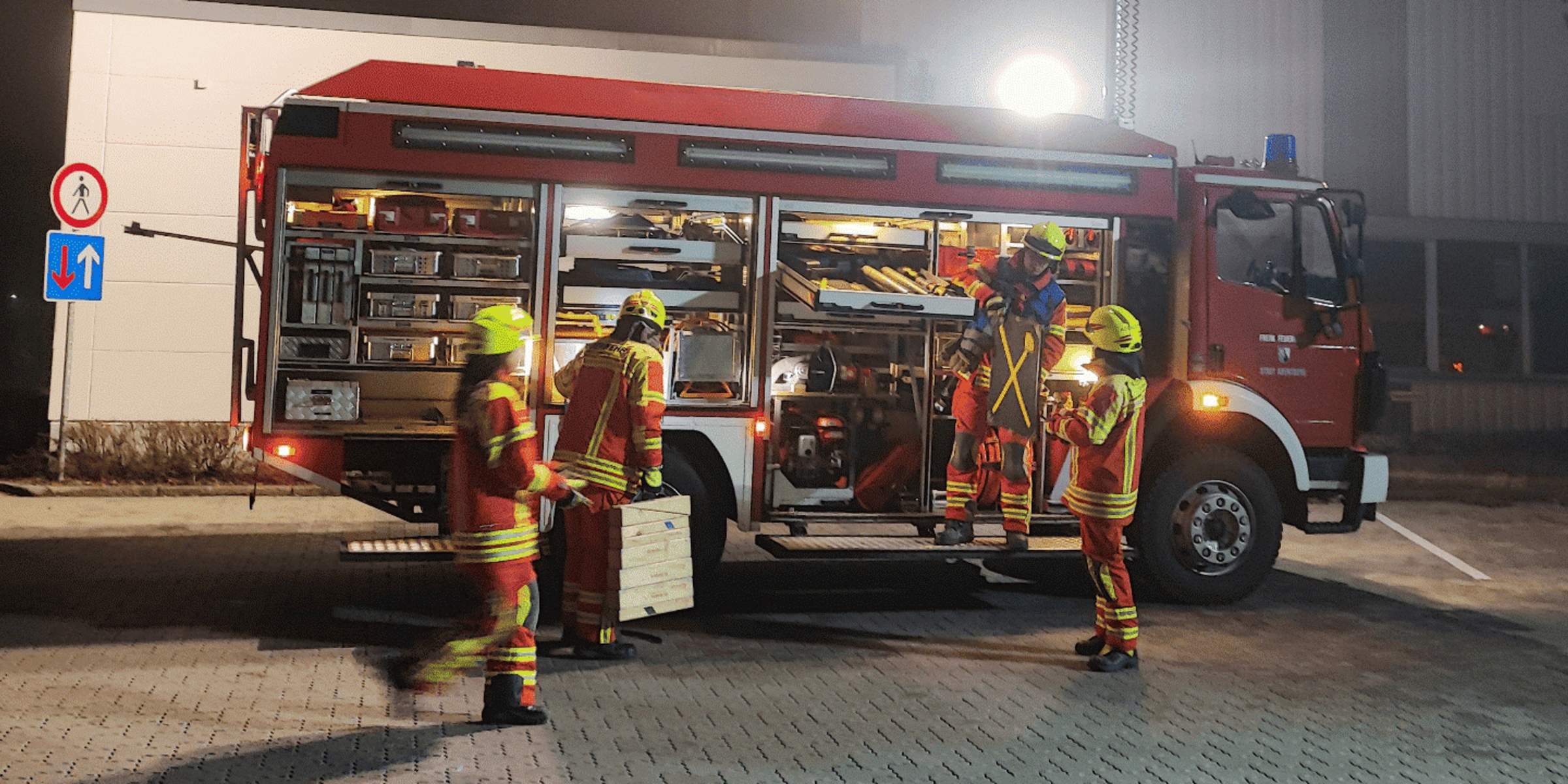 Firefighters standing in front of a fire truck on duty