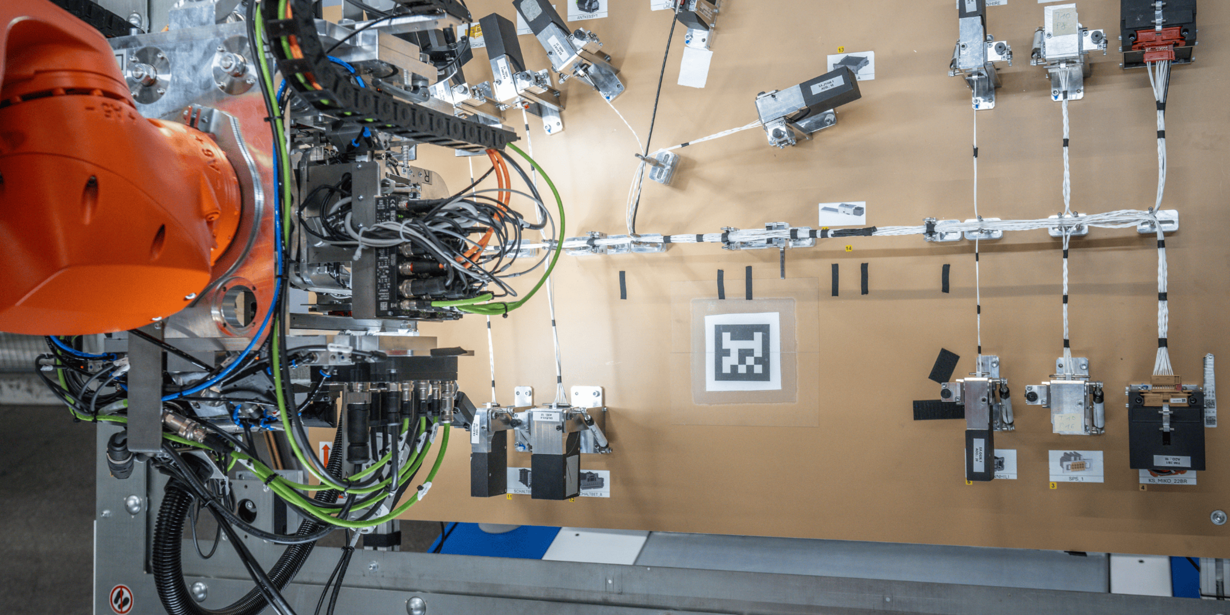 Robotic arm working on a wiring harness