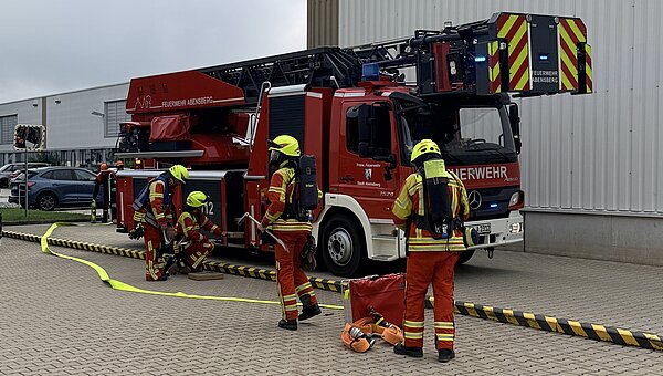 Fire fighters in front of the fire truck during the evacuation drill.