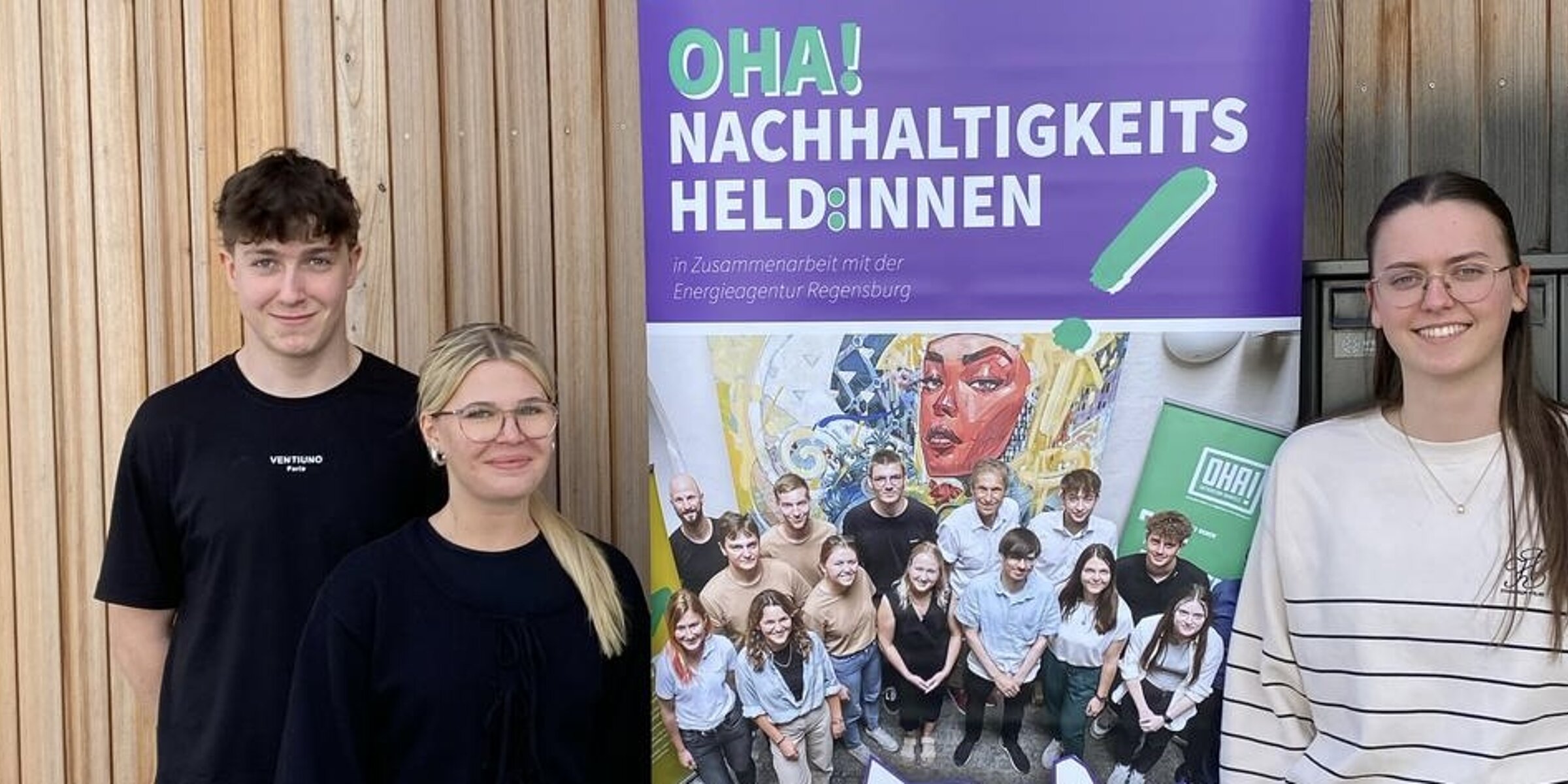 Kroschu trainees in front of a display about the OHA! Sustainability Heroes project.